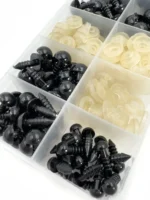 Phildar black safety eyes and light-coloured locking washers in storage compartments